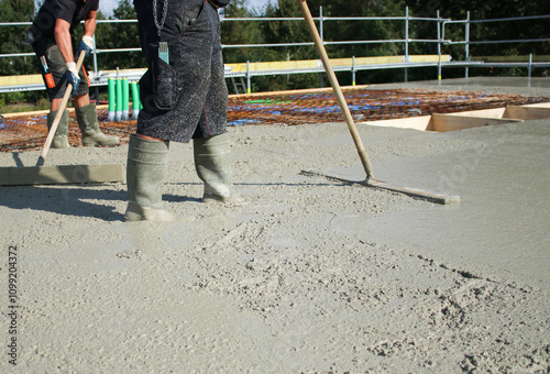 Workers filling the second floor ground with concrete, core and shell construction building  photo