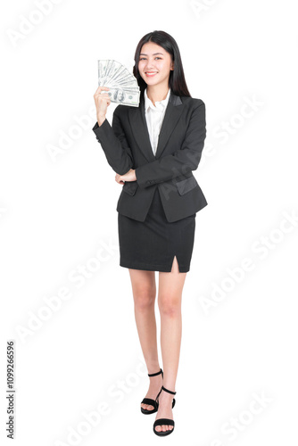 Full length portrait of a business woman , beautiful Asian girl with business office suit holding money US dollar bills in hand isolated on a transparent png background , business people concept.