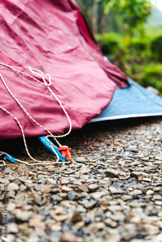 Setting up a flysheet for extra protection against wind, rain, or sun, camping concept