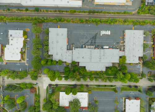 A city street view with a lot of parking lots and buildings
