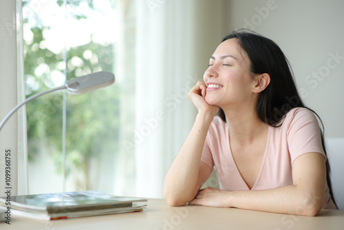 Free Download Happy asian woman relaxing in a desk in a room - GFXLoad