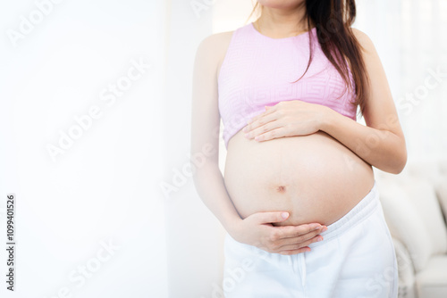 Asian pregnant woman relaxing at home. Free Download Asian pregnant woman relaxing at home. - GFXLoad