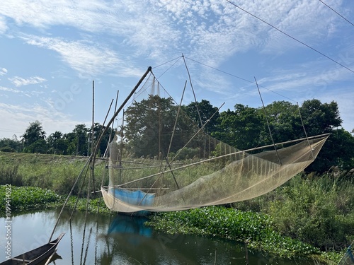Wallpaper Mural Fishing net  in Majuli island Assam, remote village image with water hyacinth  Torontodigital.ca