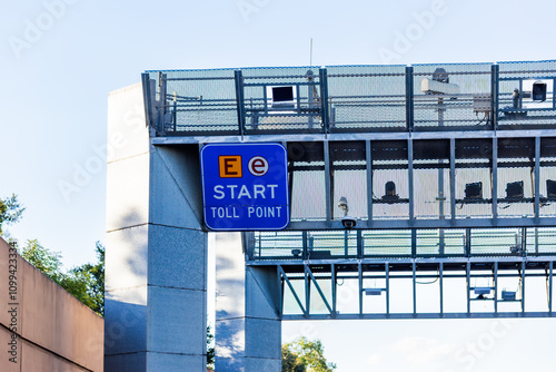 E-tag toll road start sign above highway with licence plate cameras photo