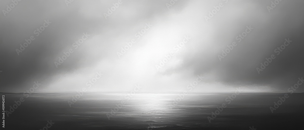 Fototapeta premium Serene black-and-white seascape with dramatic clouds.
