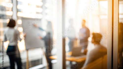 Teamwork Blur: A blurry view of an office team collaborating behind a glass partition.
 photo