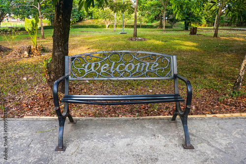 View of a lounge chair in the garden under a tree photo