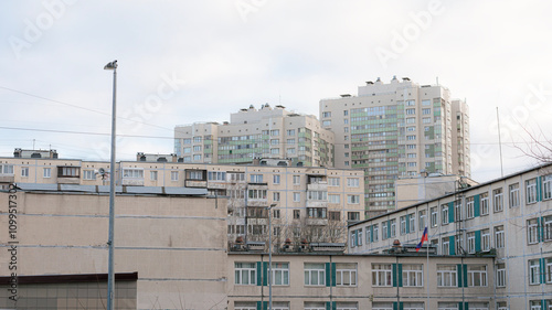 View of panel and monolithic residential buildings of varying heights in a suburban district of Saint Petersburg, Russia. Urban housing scene. photo