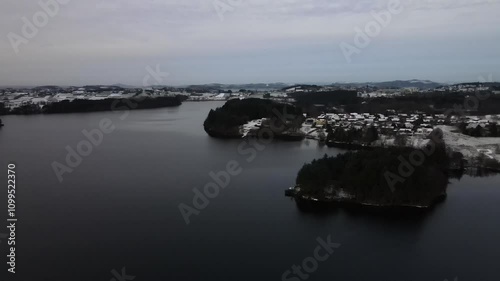 Aerial Drone Shot Over a Snowy Suburban Area During Winter Under Cloudy Skies photo