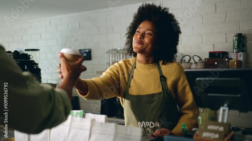 African American barista giving a take-away coffee to a customer