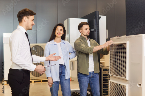 Air conditioner salesman assisting family consumers in choosing, buying heating and cooling product for home, manager offers great selection in market shop, happy customers best offer consultation photo