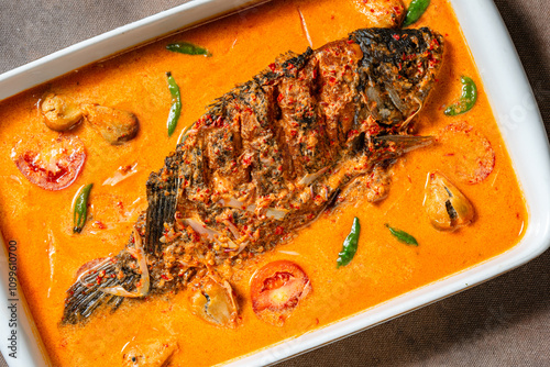 Fried Gourami cooked in spicy sour curry with asam cikala photo