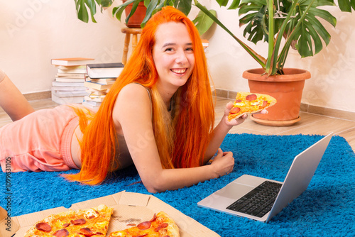 Relaxed home lifestyle with pizza, books, and technology photo