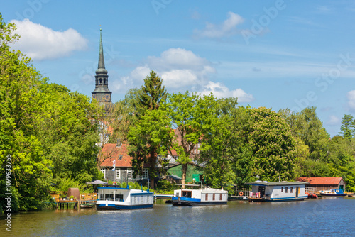 Burggraben at Stade with houseboats and belltower of St Cosmae church in background photo