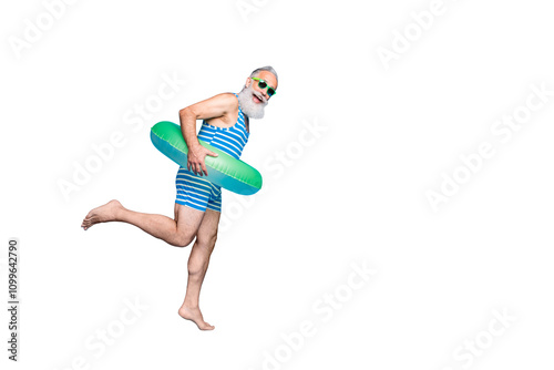 Full length photo of cheerful retired person with eyeglasses eyewear white hair holding toy ring wearing striped bathing suit isolated over blue background photo