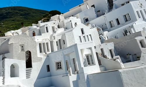 Serene Architecture of Whitewashed Buildings Under Clear Blue Sky in Aegean Island, Showcasing Traditional Cycladic Style and Charming Details
