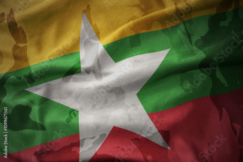 colourful waving flag of myanmar on the old army khaki texture background. military concept. photo