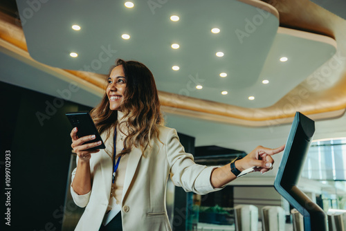 Professional woman using touchscreen in a modern corporate office