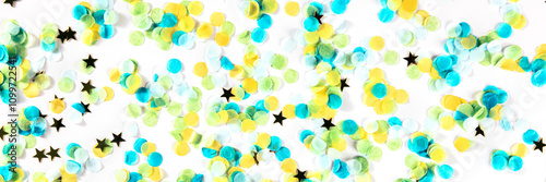 Festive panorama with confetti. Carnival greeting card with golden stars on a white background