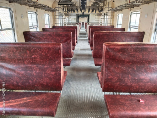 Indian passenger memu train interior. New general coach. Empty cabin of a modern passenger train. Empty blue seats inside train cabin, corridor view, no people. photo