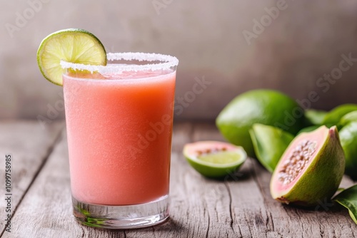 cocktail photography, a salt-rimmed guava margarita in a clear glass, with lime wedges on a wooden table, exuding a refreshing vibe
