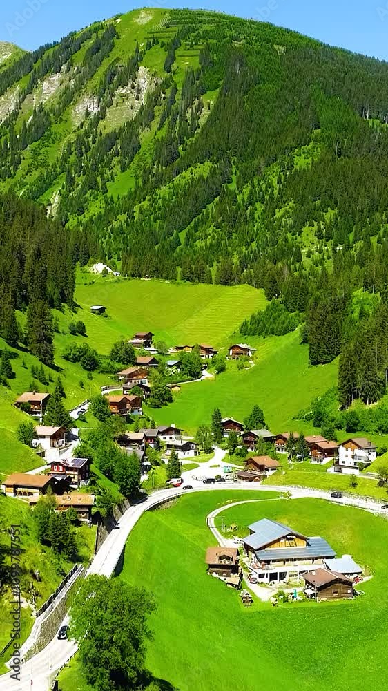 custom made wallpaper toronto digitalSmall town in the Swiss countryside grassy rolling hills forests on mountains, vertical video.