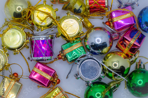 Christmas tree decorations scattered in a background.