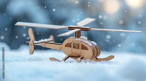 Wooden helicopter with spinning rotor blades on snow background photo