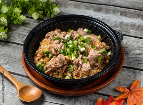 shacha mutton fried rice with green onion and spoon served in bowl isolated on wooden table side view of taiwan food photo