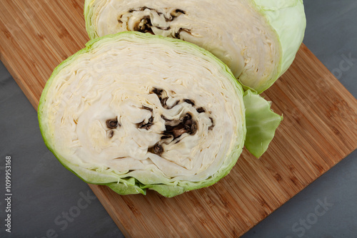 Putrid white cabbage. Vegetable looks normal from the outside, but rotten inside. Rotten cabbage head. Expired food. Concept - Improper storage of vegetables photo