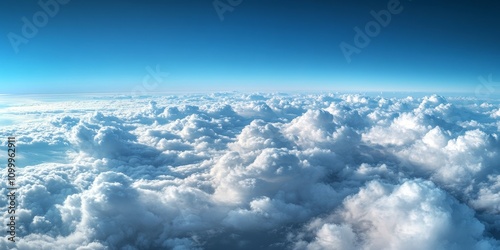 Aerial view of a sky scape featuring blue and white fluffy clouds, captured from an airplane window. This cloudscape showcases the beauty of clouds from a unique aircraft perspective. photo