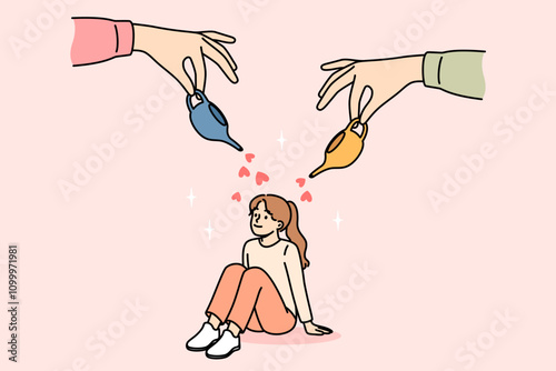 Parents care and give love to little girl by showering baby with miniature jugs with hearts. Happy child sitting on floor, growing up in loving family thanks to parents investing in daughter
