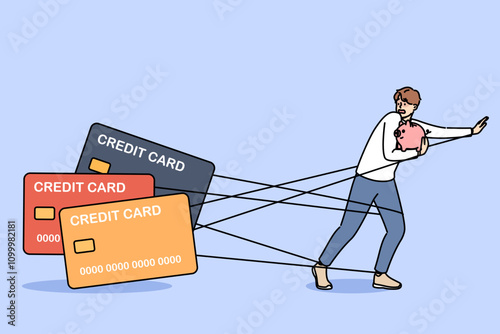 Man debtor has become hostage to loans and is running away from bank cards holding piggy bank in hands. Problems of credit dependence are caused by lack of freedom of guy who owes money
