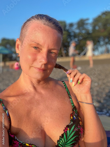 woman in a swimsuit on the background of a pebble beach in Kobuleti, Georgia photo