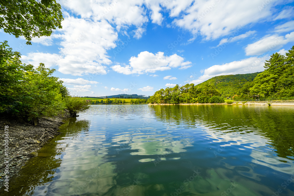 Obraz premium View of Lake Diemelsee and the surrounding landscape. Idyllic nature at the reservoir in Sauerland. 