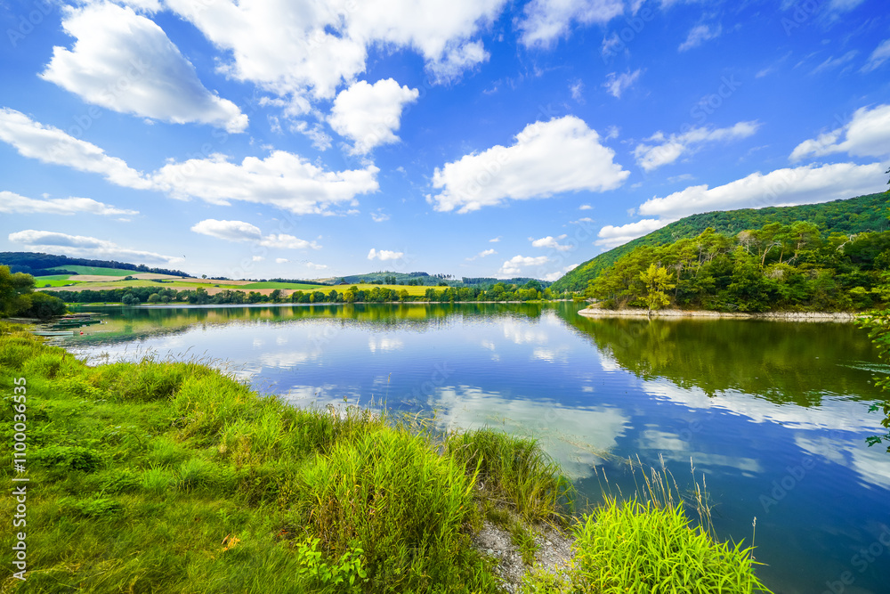 Fototapeta premium View of Lake Diemelsee and the surrounding landscape. Idyllic nature at the reservoir in Sauerland. 