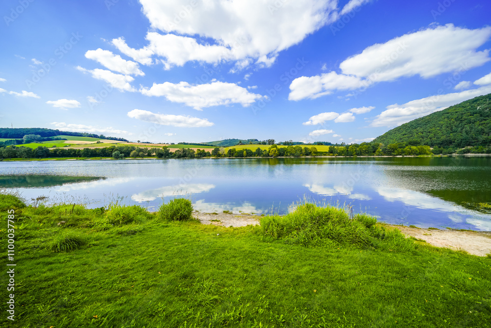 Fototapeta premium View of Lake Diemelsee and the surrounding landscape. Idyllic nature at the reservoir in Sauerland. 