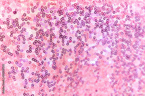 festive background of pink shiny sequins close up, selective focus