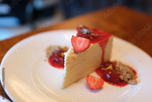 white cake with strawberry jam Close-up of a female chef stirring strawberry jam in a saucepan with a silicone spatula in a professional kitchen.