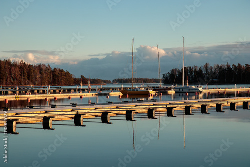 Sea marina in autumn, abandoned sailboats in a calm sea, empty marina harbor , autumn sailing season in Finland photo