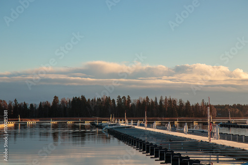 Sea marina in autumn, abandoned sailboats in a calm sea, empty pier in harbor , autumn, short sailing season in Finland photo