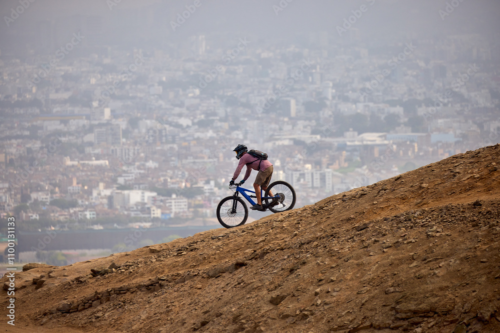 Fototapeta premium Carving down the epic trails of El Morro Solar. Whit the view of pacific Ocean and Lima on the background. Chorrillos, Lima, Peru