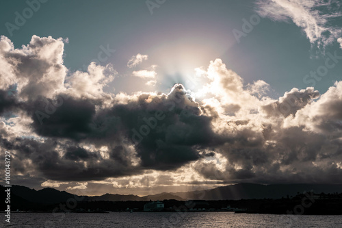 harbor of lihue with spectacular rays of sunshine and clouds, kauai, hawaii photo
