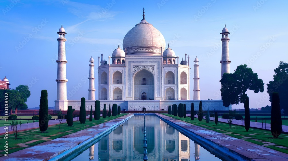 Obraz premium Taj Mahal at sunrise reflecting in the water with its marble dome, minarets, and beautiful architecture, a famous landmark and symbol of heritage in Agra, India