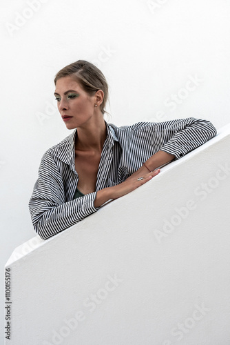 Beautiful fashion model posing on white wall. Fashion summer concept.
