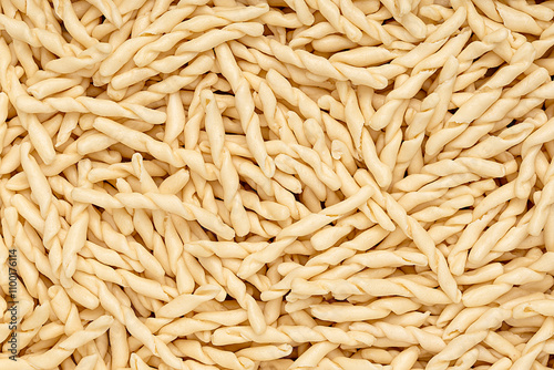 Fotografie Macro photography of raw pasta strozzapreti, macaroni; twisted noodles; durum wh