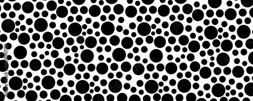 Black circles of various sizes on a white background. Seamless vector pattern.