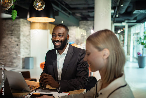 Business team collaborating on project in modern office environment