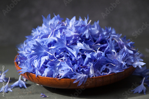 Cornflower petals in a wooden plate