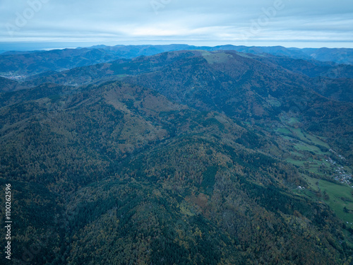 Aerial view of majestic mountains and serene forest in a picturesque valley, Thann, France. photo